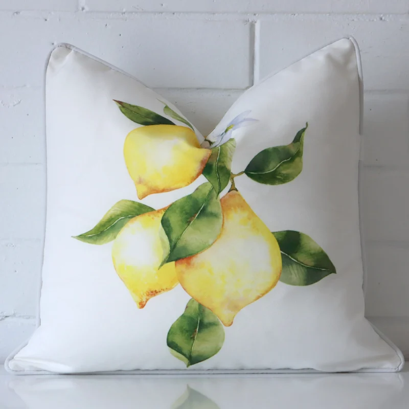 lovely-lemons-waterproof-outdoor-cushion-cover-sc948-45 Cushion positioned in front of a brick wall. It has square dimensions and is made from an outdoor material.