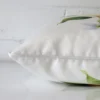 Lateral angle image of an outdoor square cushion. The design is highlighted along its seams.