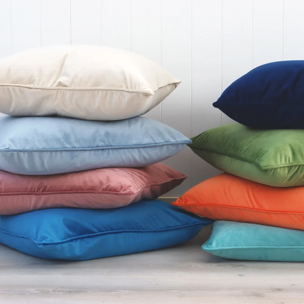 Lovely vibrant velvet cushions are shown in towers infant of a wall.