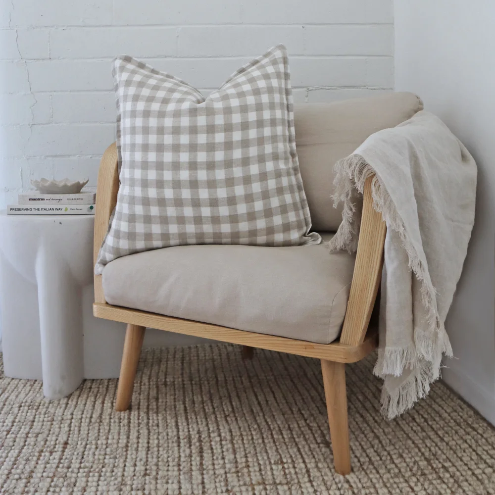 A low chair has been styled with a gingham cushion.