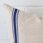 Close up image of top corner of this striped blue cushion. This shows the linen fabric and square shape up close.