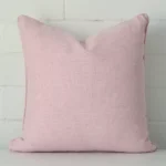 A bold linen cushion in a sleek square size with a baby pink tone of colour.