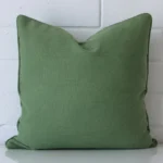 Vibrant sage green cushion cover constructed from linen fabric and shown in a square size.
