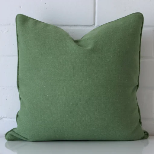 Vibrant sage green cushion cover constructed from linen fabric and shown in a square size.