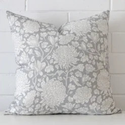 A bold floral linen cushion in a sleek square size with a light blue tone of colour.