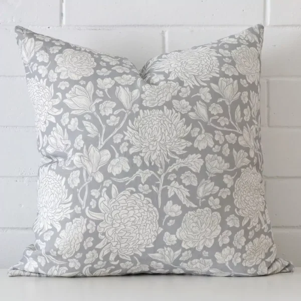 A bold floral linen cushion in a sleek square size with a light blue tone of colour.