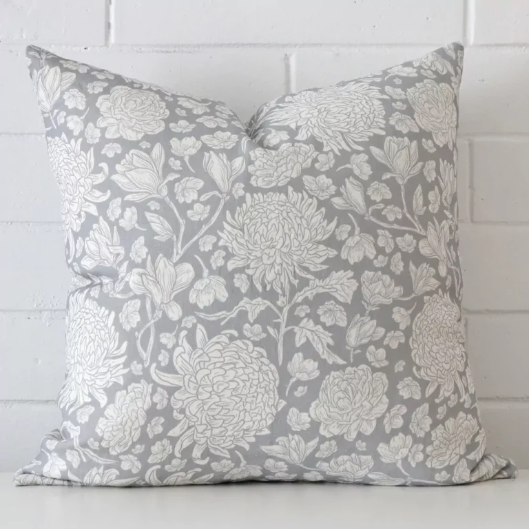 A bold floral linen cushion in a sleek square size with a light blue tone of colour.