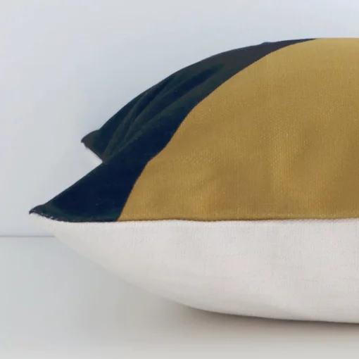 Square geometric cushion cover in colourful colour sitting flat. The sideways viewpoint shows the seams of the linen material.