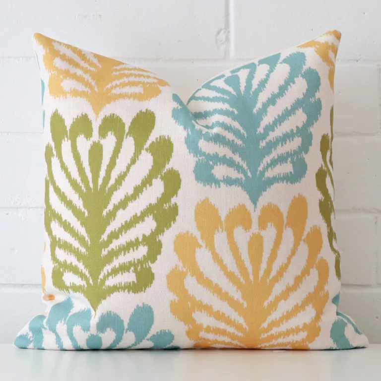 A linen square cushion cover that has a unique patterned design is shown vertically against a brick wall.