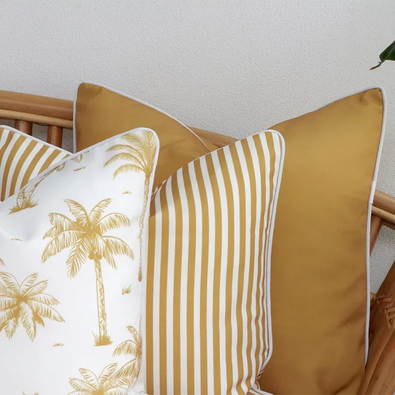 A close-up image of 3 mustard outdoor couch cushions provides a thorough view of the colour hue and style.