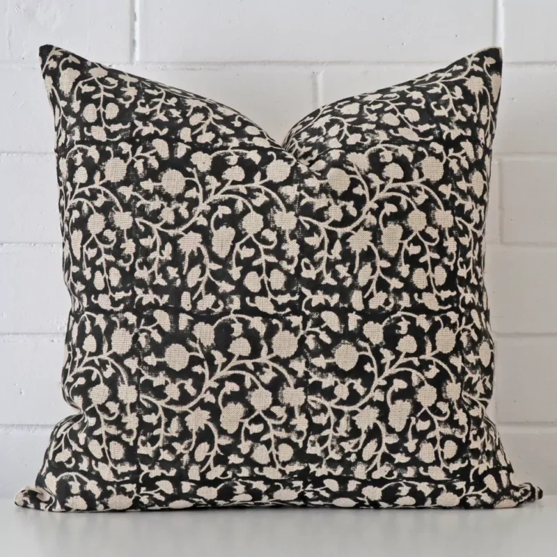 naples-floral-designer-cushion-cover-art112-55c Floral cushion positioned in front of a brick wall. It has large dimensions and is made from a designer material.