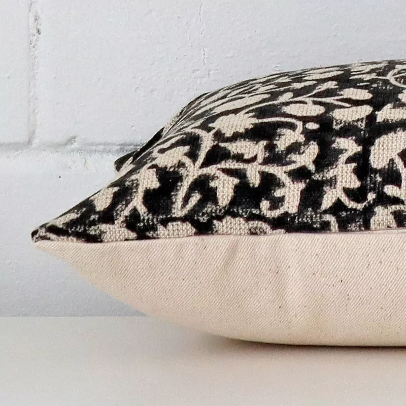 Side image of a designer large cushion cover. The floral design is visible from the side showing the attachment of the panels.