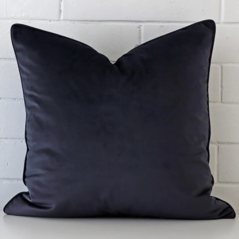 navy-velvet-cushion-cover-55cm-x-55cm-sc775-55b Navy cushion leans elegantly against a brick wall. It has been crafted from a high quality material and has a large shape.