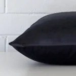 A velvet navy cushion cover shown laying on its side. It has a large size.