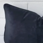 This image shows a navy cushion cover in a rectangle size from a very close range. The velvet material is more clearly shown.