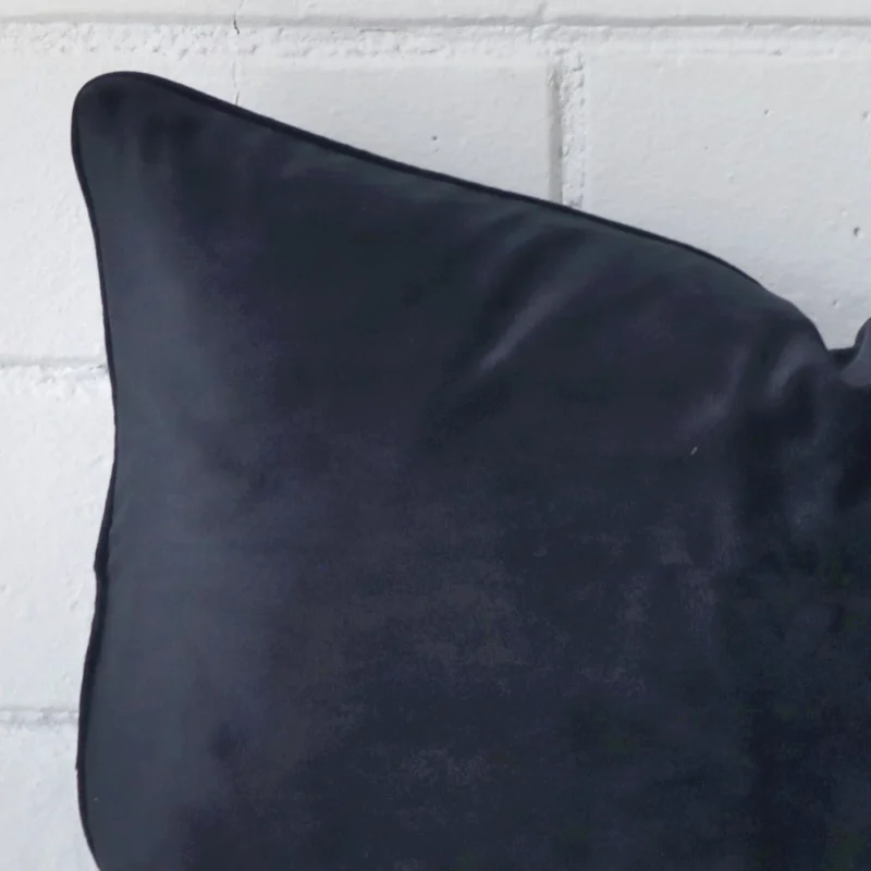 This image shows a navy cushion cover in a rectangle size from a very close range. The velvet material is more clearly shown.