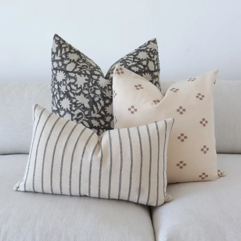 The set of 3 Nellie couch cushions are arranged neatly on a sofa.