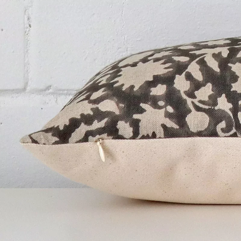 Horizontal edge view of front and back panels of a floral designer cushion in a large size.