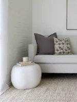 Two cushions from the set of 5 Nellie sofa cushions sitting on a light grey sofa.