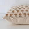 Side shot showing the seam of this large cushion that features a floral motif on its designer material.