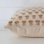 Side shot showing the seam of this large cushion that features a floral motif on its designer material.