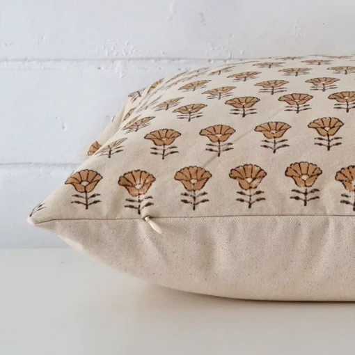 Side shot showing the seam of this large cushion that features a floral motif on its designer material.