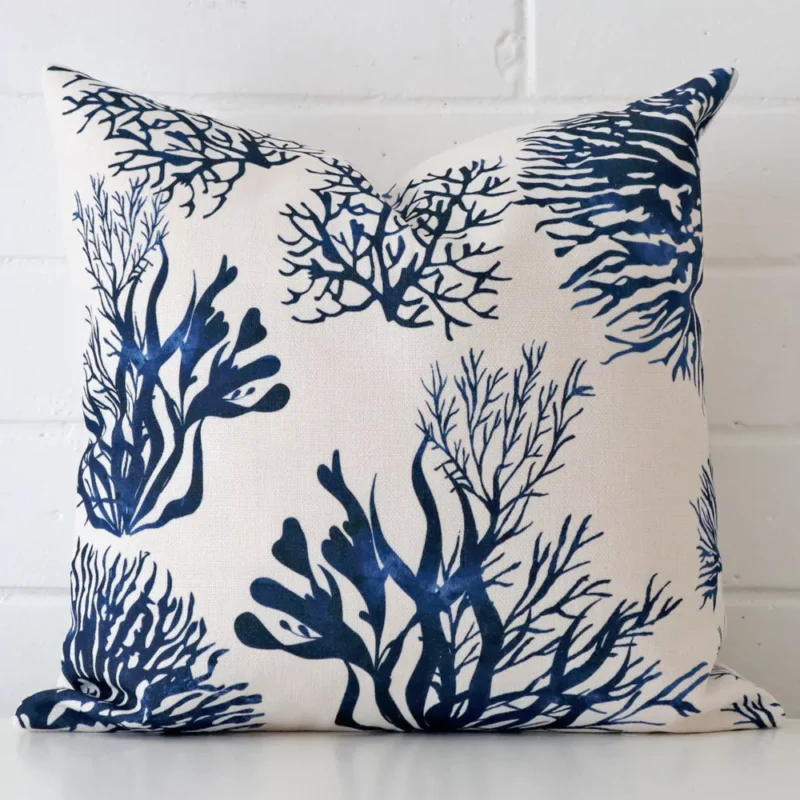 new-england-blue-coral-cushion-cover-45cm-x-45cm-sc825-45 Patterned cushion leans elegantly against a brick wall. It has been crafted from a high quality linen material and has a square shape.