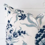 Close up image of top corner of this floral cushion. This shows the linen fabric and square shape up close.