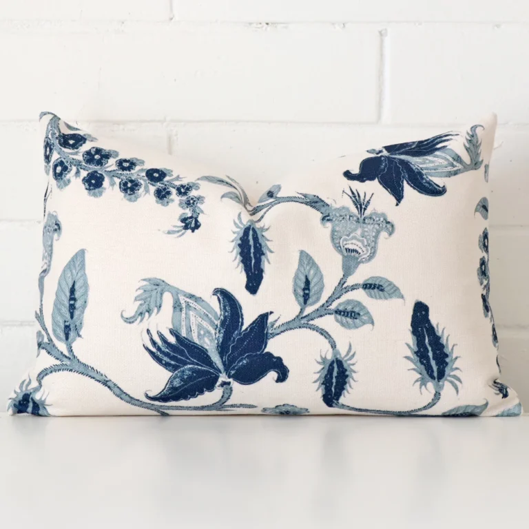 Cushion positioned in front of a brick wall. It has rectangle dimensions and is made from a linen material.