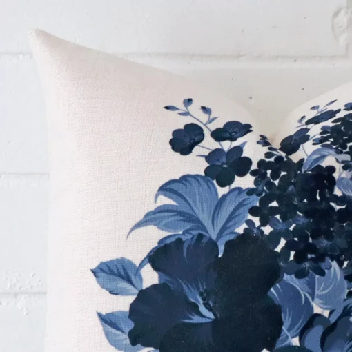 A zoomed in photo of the corner of a floral cushion that has linen fabric and a SIZE size.