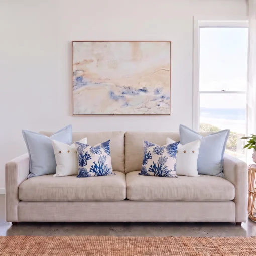 new-england-sofa-cushions-set---6-covers---colc1165 Six cushions in pairs of sky blue linen, button detail, and coral print, on a sofa.