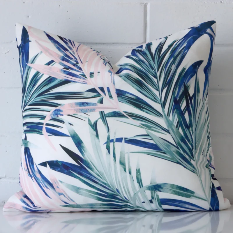 ohana-palm-waterproof-pink-outdoor-cushion-cover-sc929-45 A hero shot of a square cushion cover. It is made from a deluxe outdoor fabric and features a pink colour.