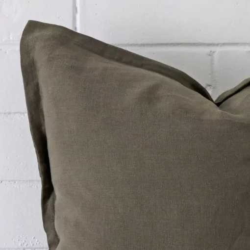 A linen large cushion’s corner has been enlarged in this shot. The detail of the olive colour is more visible.