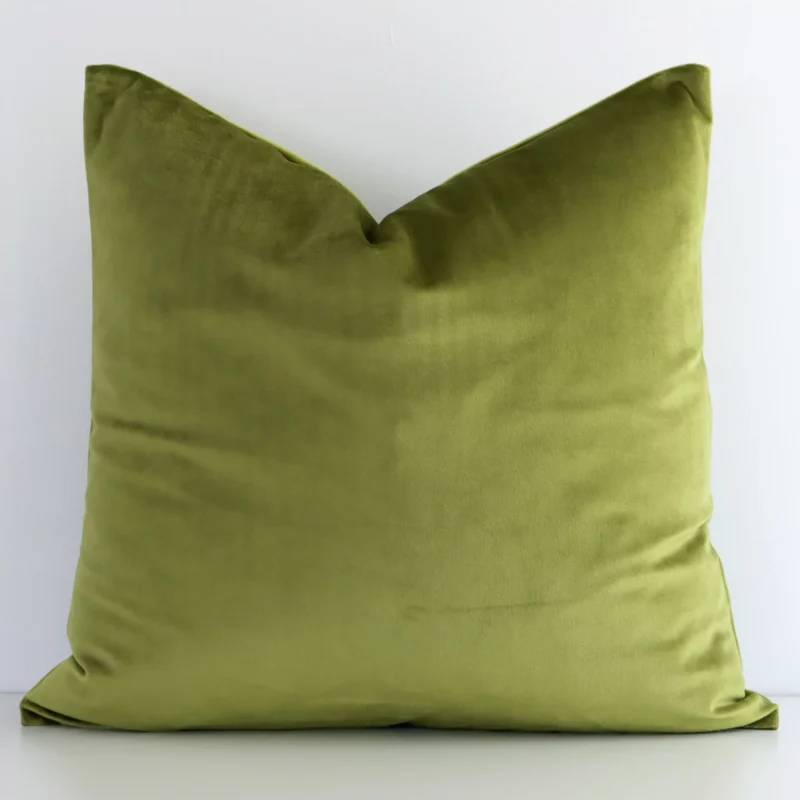 olive-velvet-linen-cushion-cover---sc504-45 An attractive solid-coloured velvet cushion in front of a white wall. It has a rectangle shape and is olive in colour.