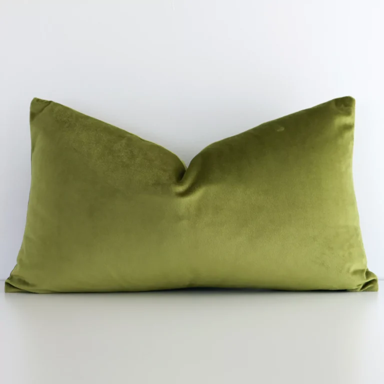 Mint rectangular cushion cover sits against a white wall. It is constructed from a superior looking velvet material and has rectangle shape.
