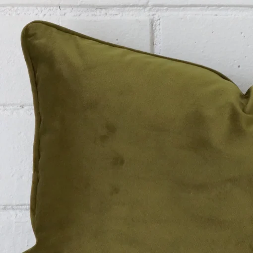 Extreme close up of a Square olive cushion. The velvet fabric is shown with a much higher degree of detail.