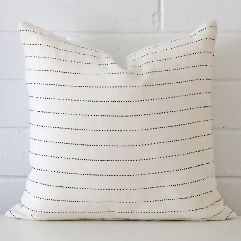 ollie-linen-striped-cushion-cover-sc1001-45b A lovely square cushion cover arranged in front of a white wall. The striped style complements the linen material.