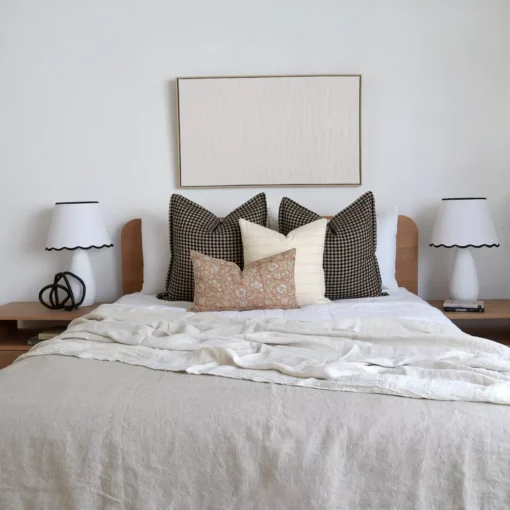 The Oscar bed cushions set is neatly arranged on a wooden bed.