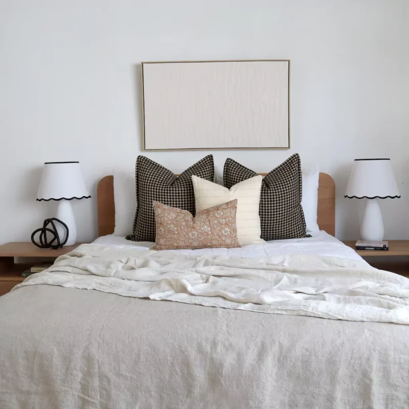 The Oscar bed cushions set is neatly arranged on a wooden bed.