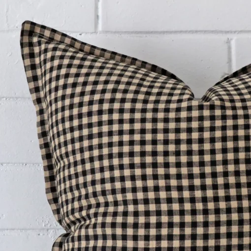 A close up image of this gingham large cushion. The image shows details of its designer fabric more thoroughly.