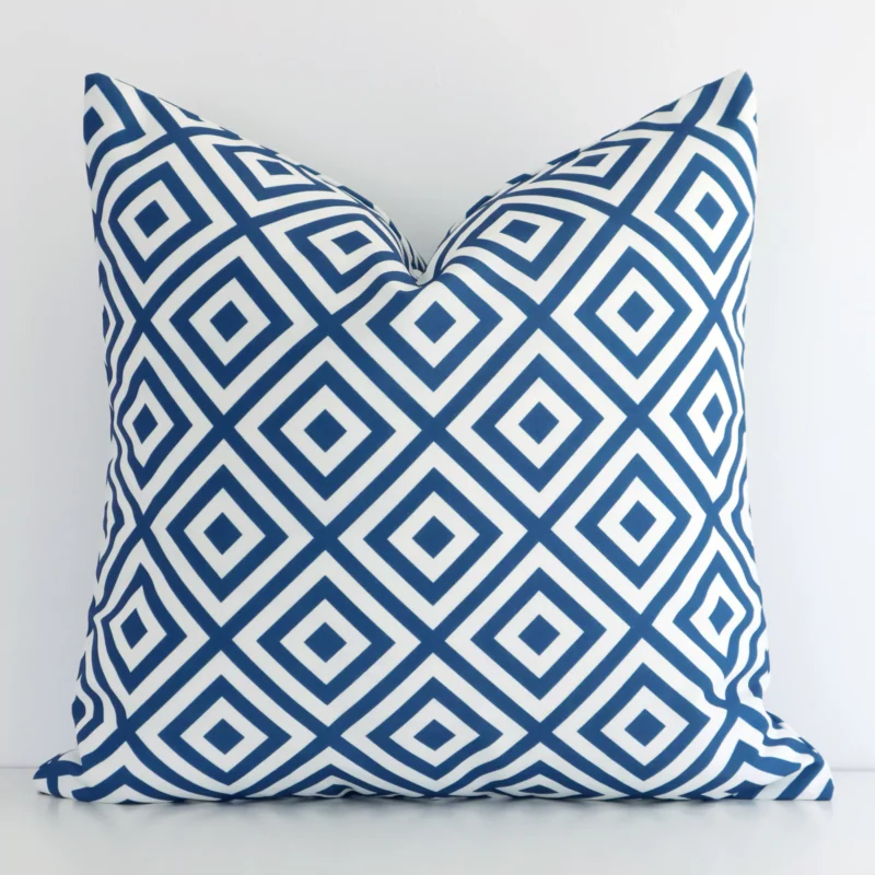 otama-geometric-waterproof-blue-outdoor-cushion-cover-sc953-45 A pretty geometric outdoor cushion cover is shown against a white wall. It features a square shape and a blue colour finish.