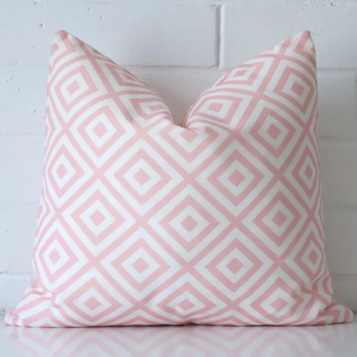A stunning square outdoor cushion in a pink colour. It has an exquisite geometric design.