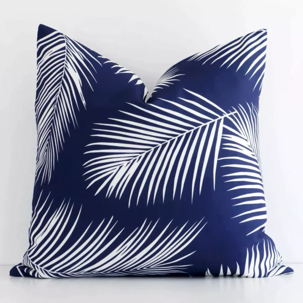 A bold palm motif outdoor cushion in a sleek square size with a navy tone of colour.