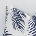Extreme close up of a rectangle navy cushion. The palm style and outdoor fabric are shown with a much higher degree of detail.
