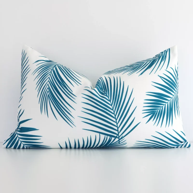 otama-palm-waterproof-rectangular-teal-outdoor-cushion-cover---rectangle---sc724-30 A pretty teal palm printed outdoor cushion cover is shown against a white wall. It features a rectangle shape.