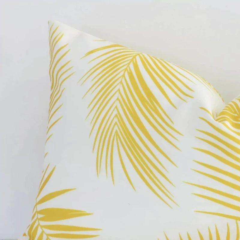 A magnified shot of a yellow palm printed outdoor cushion cover in a rectangle size.