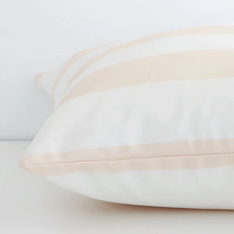 Beige striped cushion cover laid on its back side. The image shows a side-on view of the outdoor material and its large dimensions.