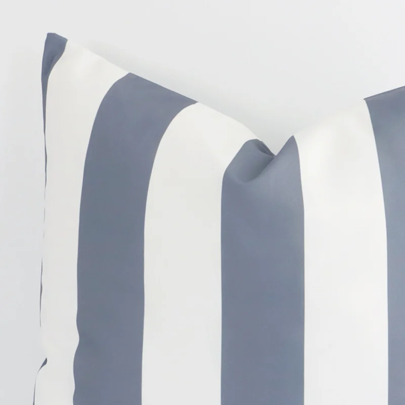 Large outdoor cushion in grey colour sitting upright in front of a white wall. It has been made from a quality outdoor material.