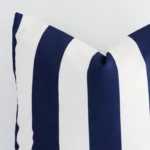 Cropped shot of top left corner of this outdoor navy striped cushion cover. This viewpoint shows the outdoor fabric and large shape with more precision.