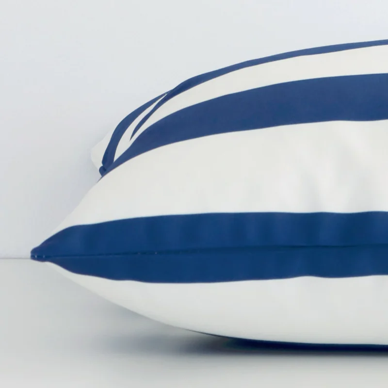 Large navy cushion laid flat. This view shows the striped style and outdoor fabric from side on.
